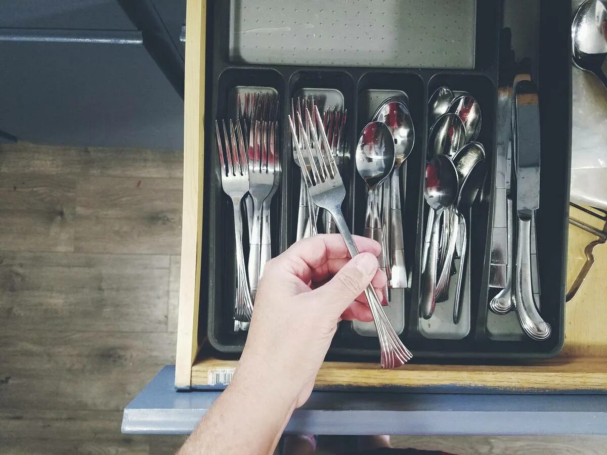 Put a fork. Forks in the kitchen. holding and using a service spoon and fork process. putting a fork in to a socket. two forks and a muttering divine.