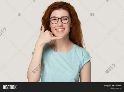 Download high-quality Smiling redhead girl glasses show call phone images