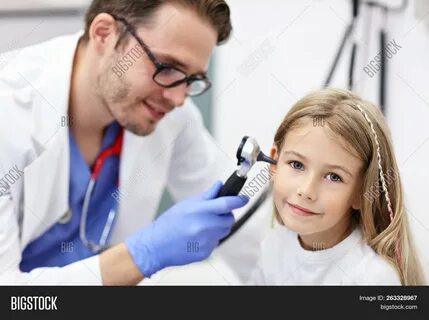 Download high-quality Male Doctor Examining Girl's Ear Otoscope images