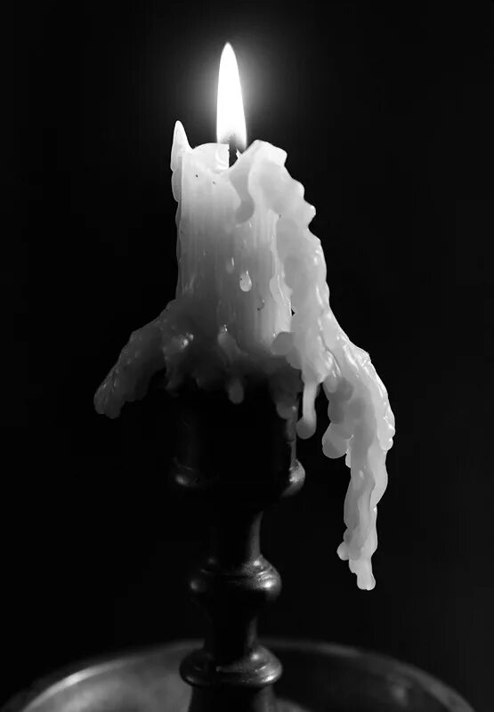 Горящая свеча гаснет в закрытой пробкой банке. Свеча. Свеча плавится. Оплывшая свеча. Свеча черно белая.