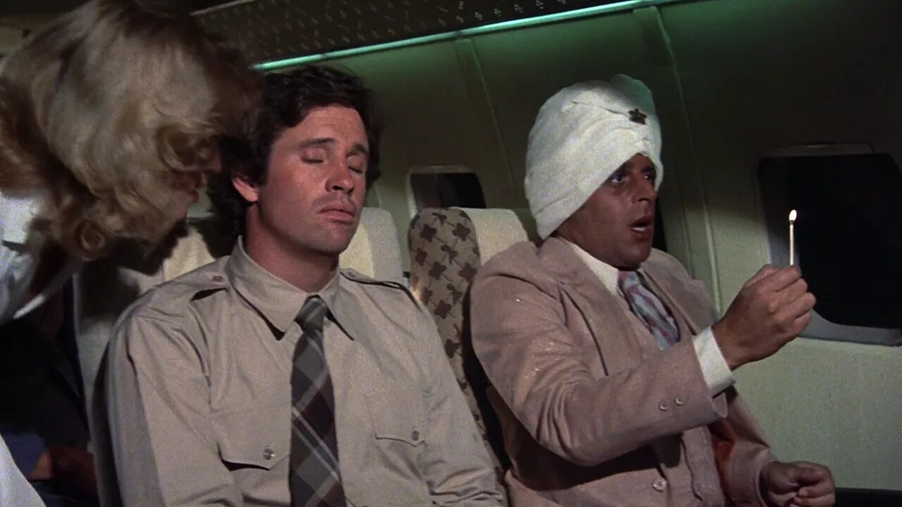 Excuse me is there here. Лесли Нильсен gif. Лесли Нильсен поезд. Лесли Нильсен фильм про самолет. Аэроплан с Лесли Нильсоном.
