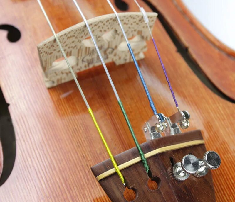 струны на скрипке. северная лира струны для скрипки. держатель струн для скрипки. струна c для скрипки. для настраивания струн скрипки.