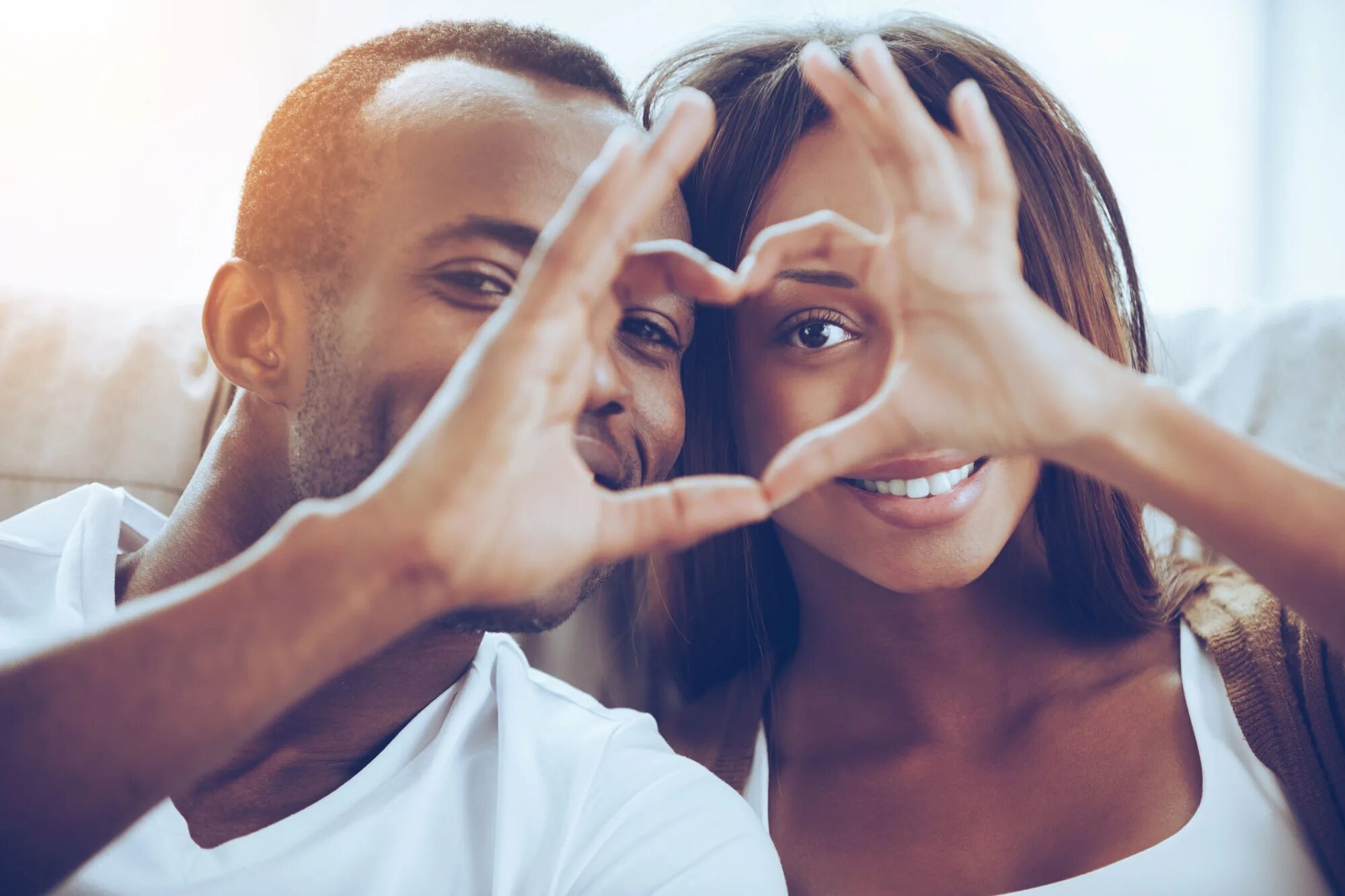 Sitting closer. Black couple in Love. American couple. Happy White American couple. Happy Black couple.