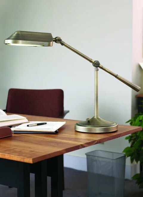 The lamp is on the desk