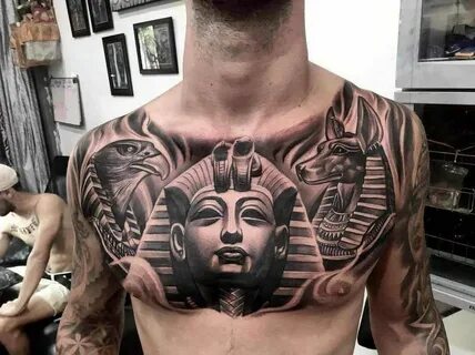 a man with tattoos on his chest has an egyptian mask and two headed sphinxs...