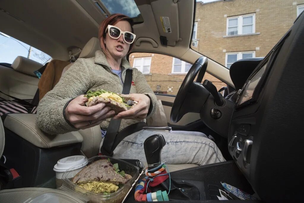 She to work by car. Eat in car. Touch girl food in car.