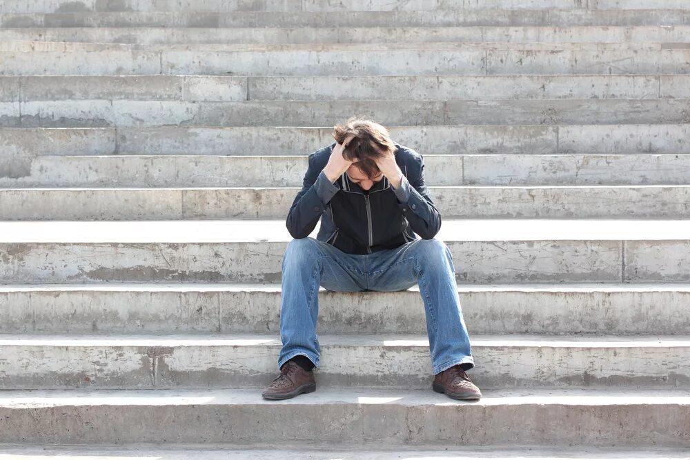 Sitting on the Stairs. Sad man sitting. Man on Stairs. Vulnerable guy.