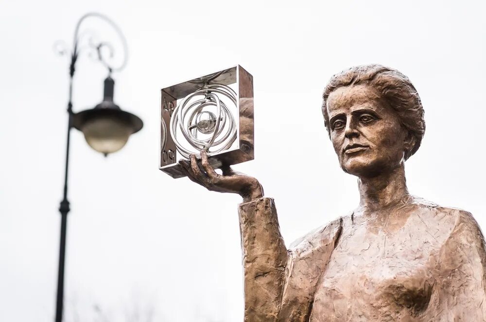 Премия марии кюри. Памятник Марии Кюри. Marie Curie с Нобелевской премией.