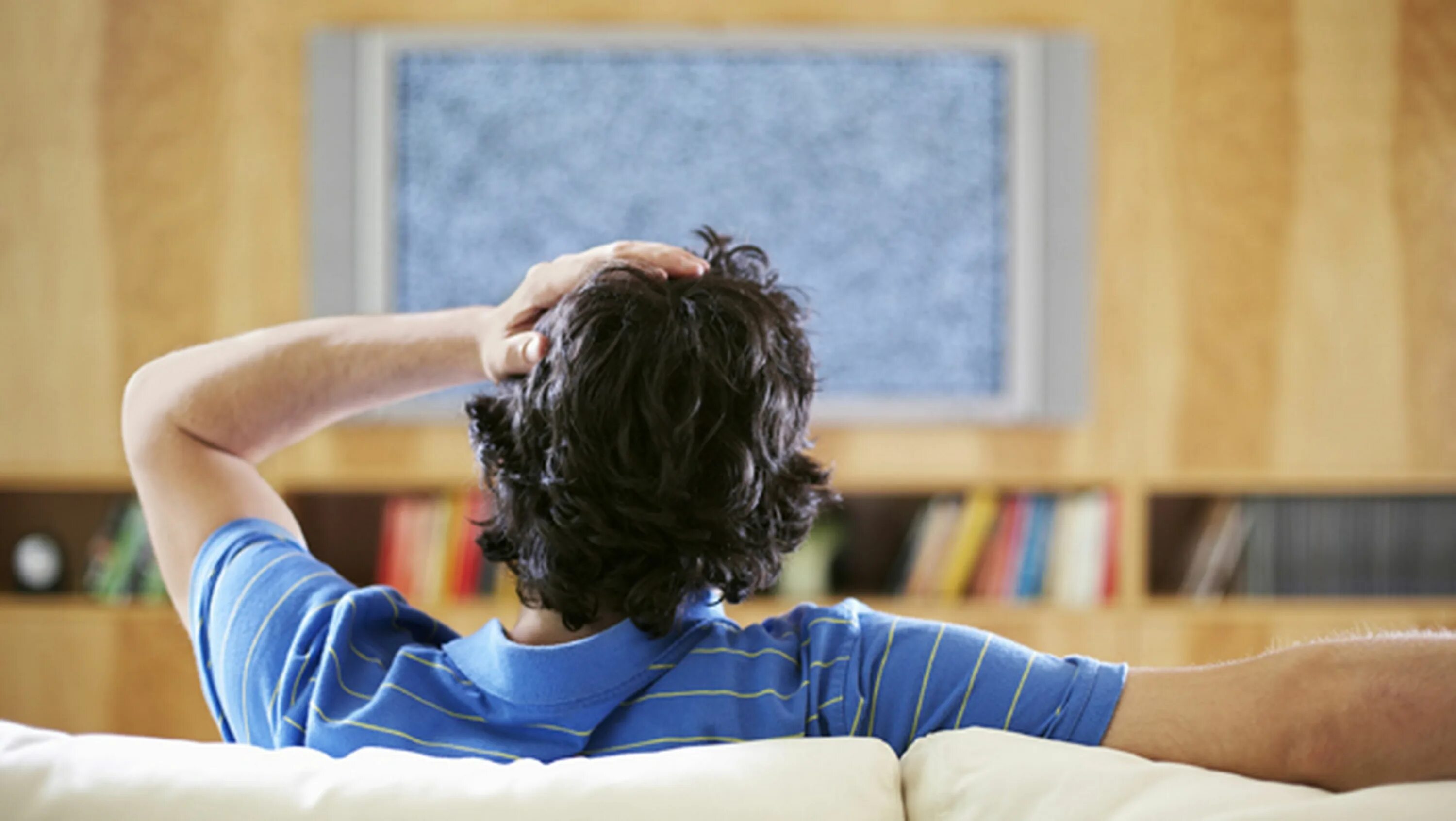 Man watching TV. Watch TV. The Effects of watching TV. A Middle-aged man watching TV.