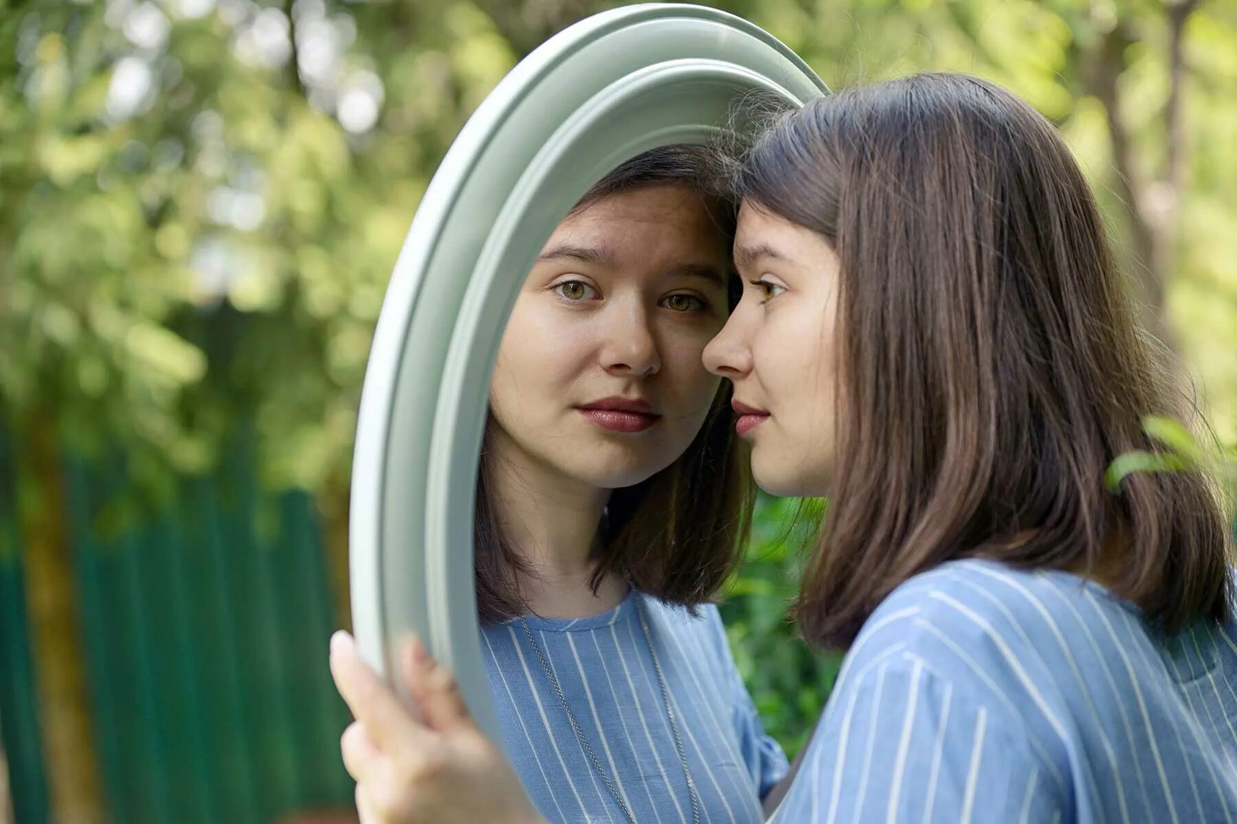 Just look in the mirror. Самооценка и любовь к себе. здоровая самооценка и любовь к себе. two teenage girls are looking in a mirror. reflection for teens.