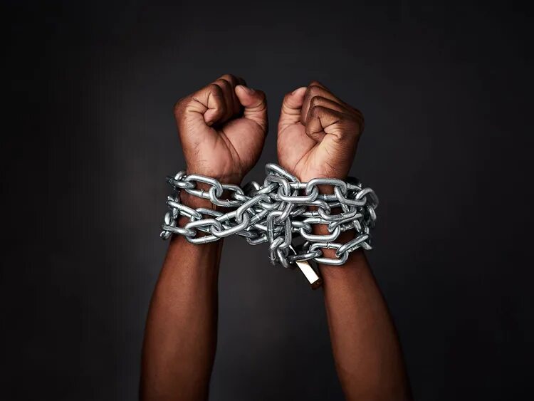 Has control over. Man in Chains. Chains on hands.