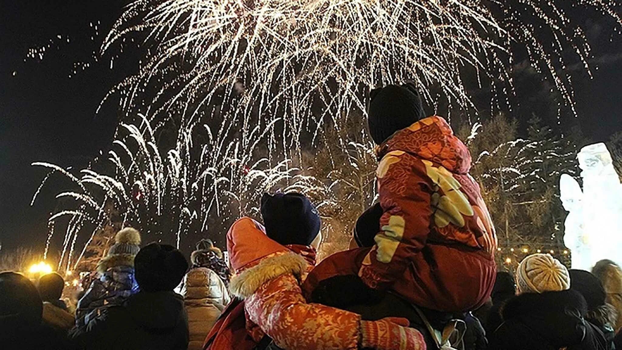 Почему на новый год запускают фейерверки. Новогодний салют на улице. празднование нового года с фейерверками. новый год бенгальские огни на улице. люди с фейерверком на улице.