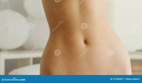 Closeup of woman s flat stomach indoors.