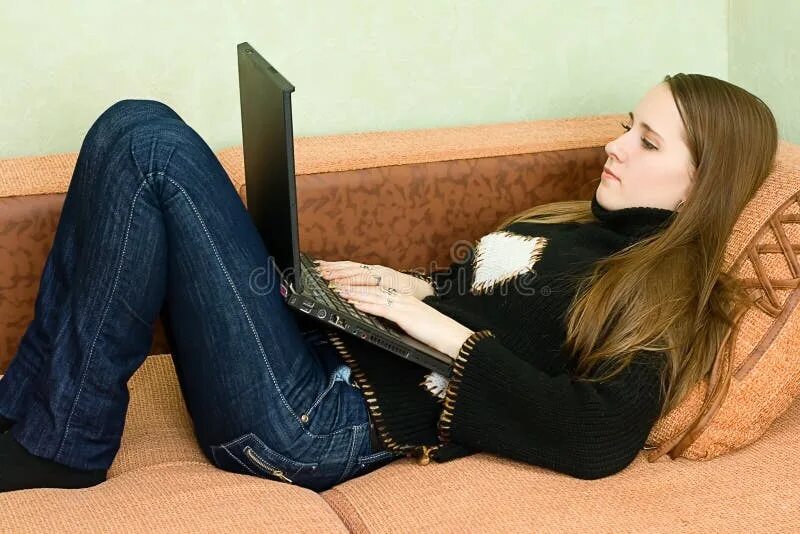 1 White Girl with Long Hair in Jeans Sitting on the Couch, Girl Stock Photo - Im