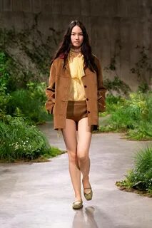 Look 2. Image may contain Clothing Coat Adult Person Shorts Fashion Accesso...