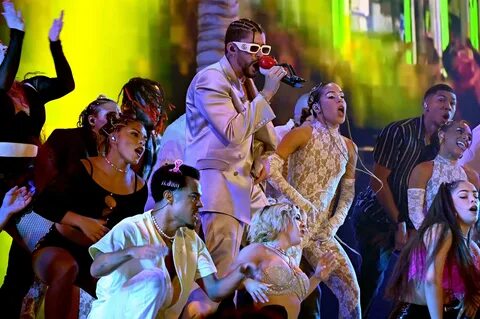 Bad Bunny performs surrounded by a crew of dancers. 
