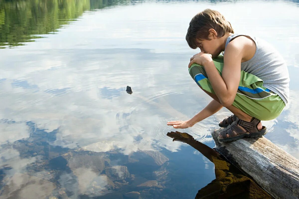 Boy paddles a raft on lake stock image. Image of homemade - 10513963