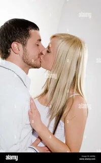 Young couple kissing, portrait Stock Photo. 