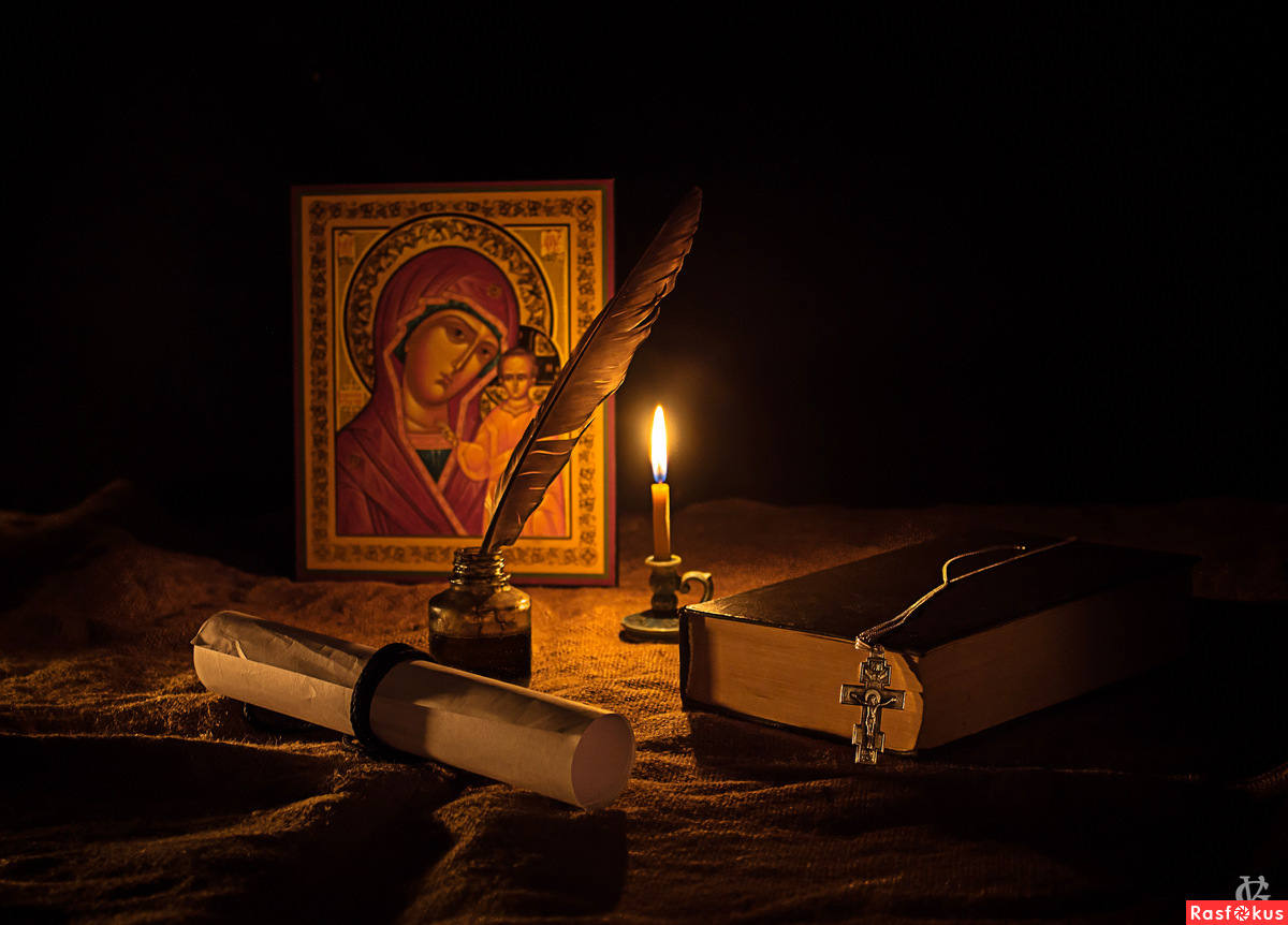 свеча перед иконой. ведьма гадает. приворот на икону. горящая церковная свеча. свеча на фоне иконы.