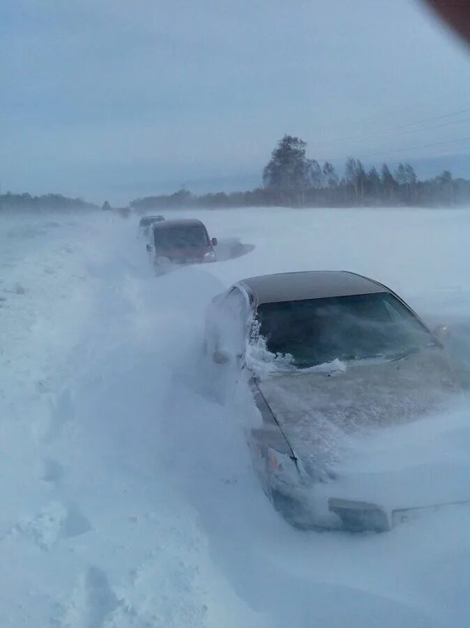 Дорогу в глубоком снегу. Снежные заносы на трассе. Машина в сугробе на трассе. Снежная буря застряли в автомобиле. Занесенная снегом дорога.