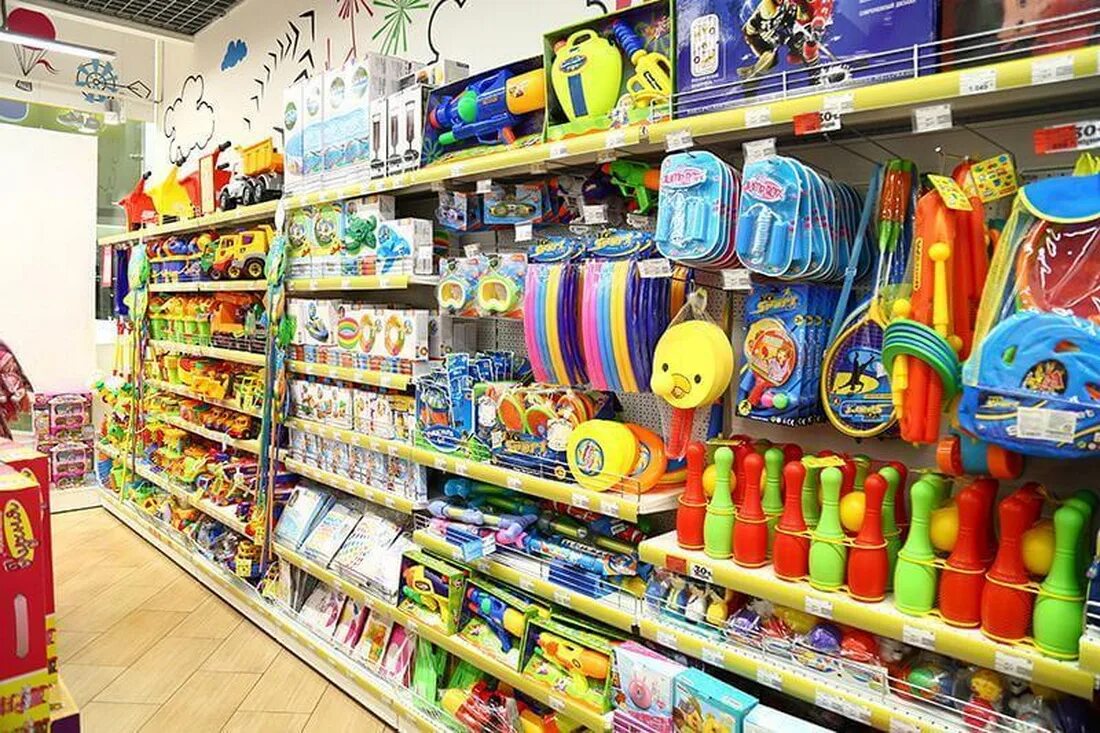 Детский магазин г. Магазин игрушек для детей. Выкладка игрушек. Выкладка детских товаров. Детские игрушки выкладка.