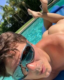 John Barrowman shared this cheeky snap as he posed by the pool. 