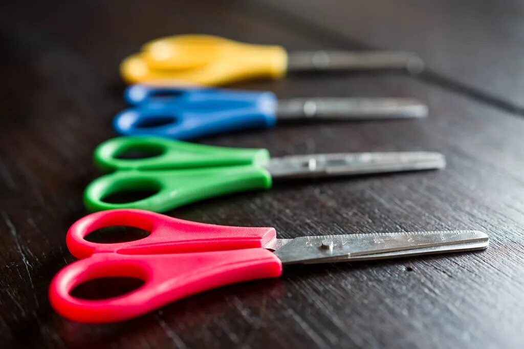 The scissors on the kitchen table. Scissors on the table. gree scissors on the table. green scissors on the table. scissors creative.