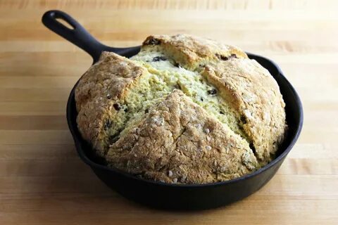 A freshly baked Irish soda bread loaf in a cast iron pan. 