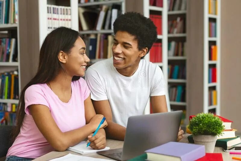 The students are watching. Two teenagers studying.