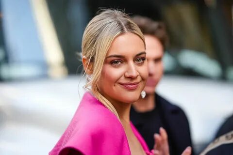 Kelsea Ballerini InStyle Interview Kelsea Ballerini smiling in a pink coat....