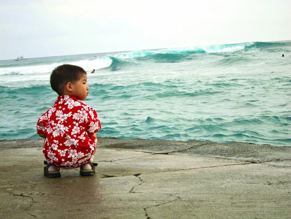 The perfect child. Squatting Beach. Kids having fun squatting. One- squatting Baby. Child sitting and standing.