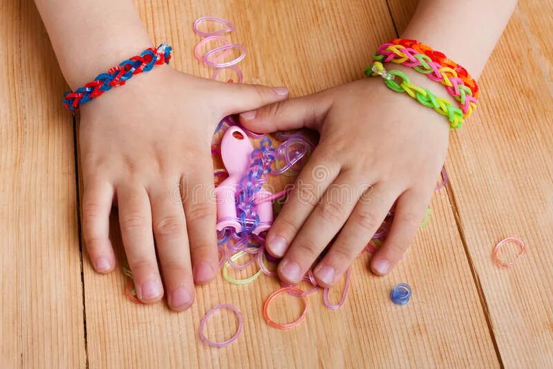 Девочка плетет браслет. Резиночки браслеты круглые. Игры для девочек с плетение резиночками. Ладони с резиночками фото. Эластичный ребенок