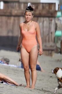 Florence Pugh seen wearing an orange swimsuit while enjoying a beach day wi...