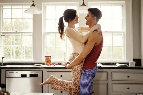 Couple flirting while making breakfast.