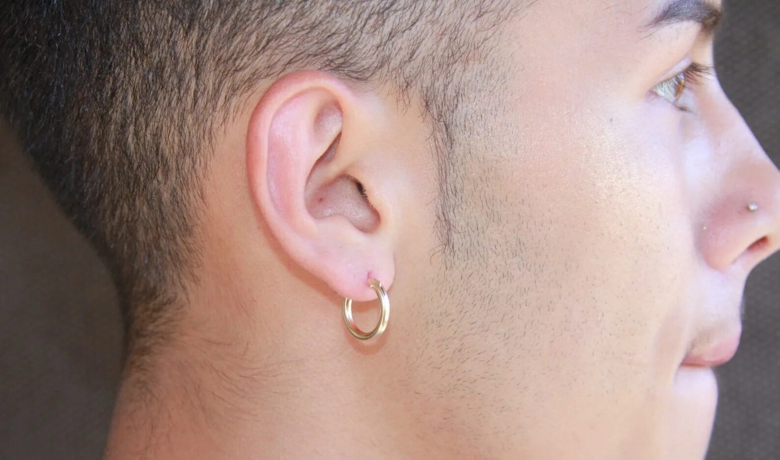 Мужское ухо. Золотая серьга мужская. Мужские серьги кольца. Золотые серьги для мужчины в ухо. Серьги кольца на ухе.