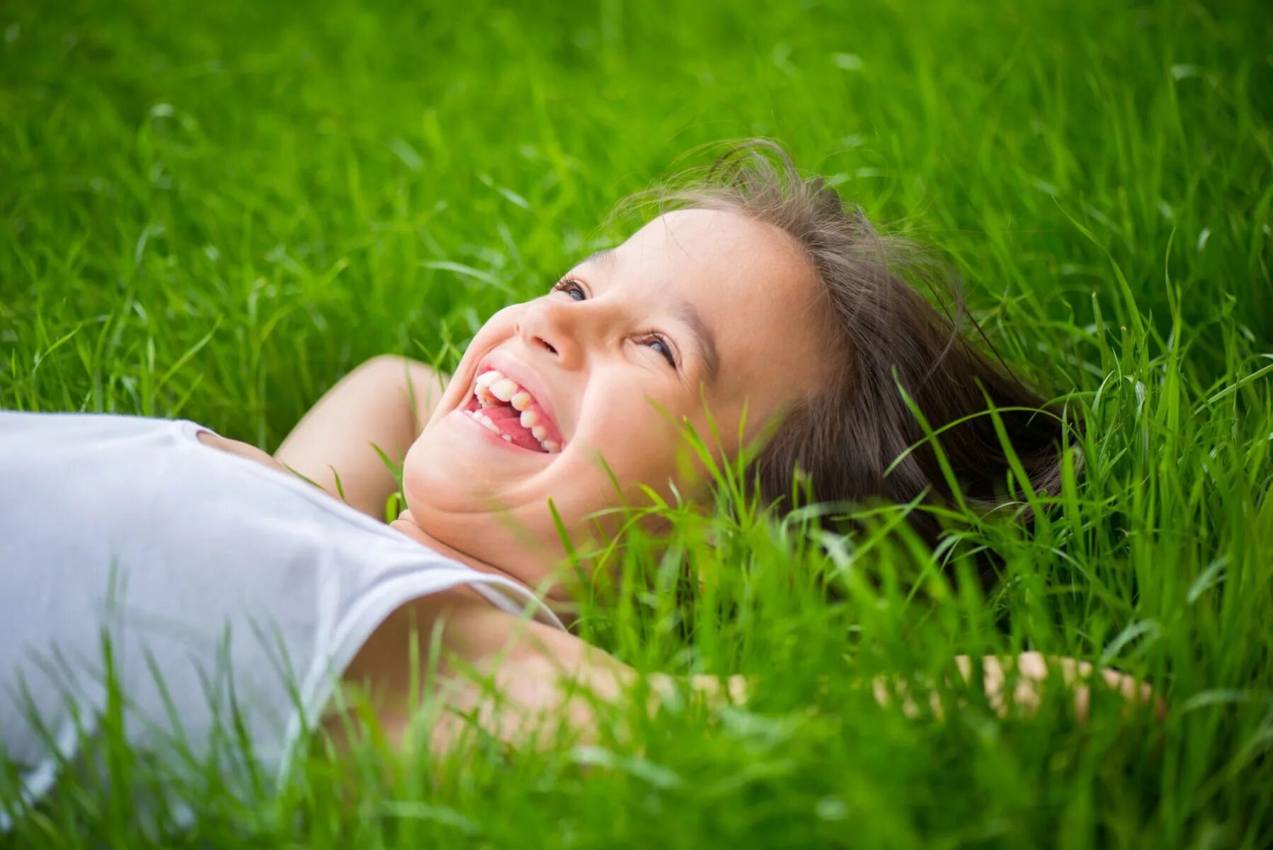 Спокойно занятие. Счастливые дети на траве. Гиперактивная девушка. Ребенок лежит на лугу. Ребено утомлён.