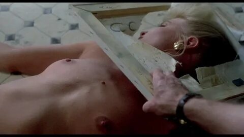 Virginia Madsen briefly flashes her tit when she gets up from the bed.