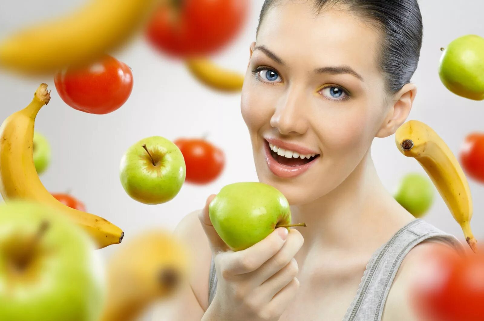 Употребление фруктов. Питание для красивой и здоровой кожи. Девушка ест витамины. Питание для красивой кожи.