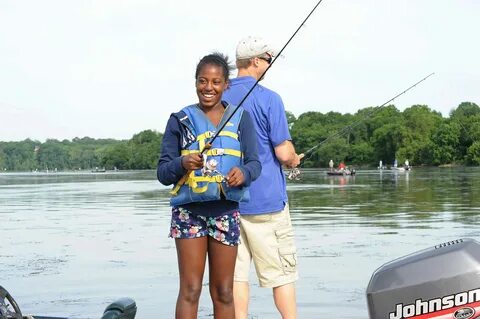 A girl smiles as she fishes.jpg.