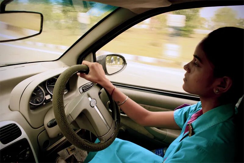 A child girl Driving a car. Driving in Baghdad. Girl which is Driving a car.