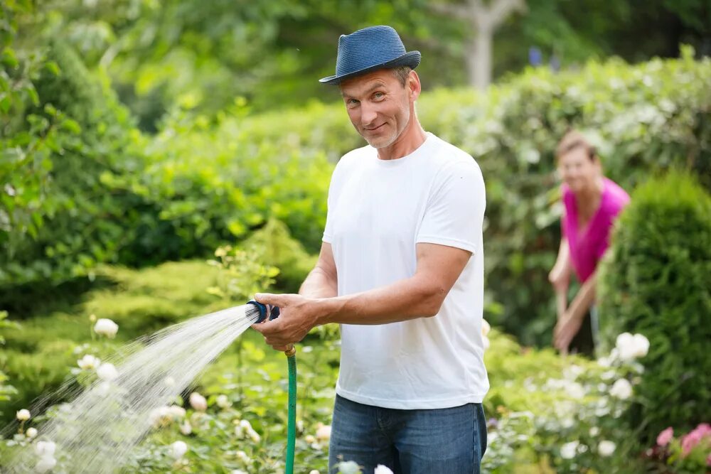 We were watering the plants. Садовник со шлангом. Мужчина со шлангом. Человек шланг. Огородник со шлангом.