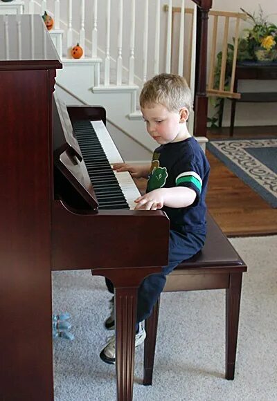 Child at the piano stock photo. Image of keyboard, black - 7305840