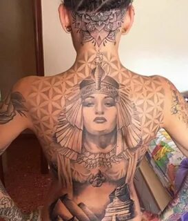 a woman with many tattoos on her back 