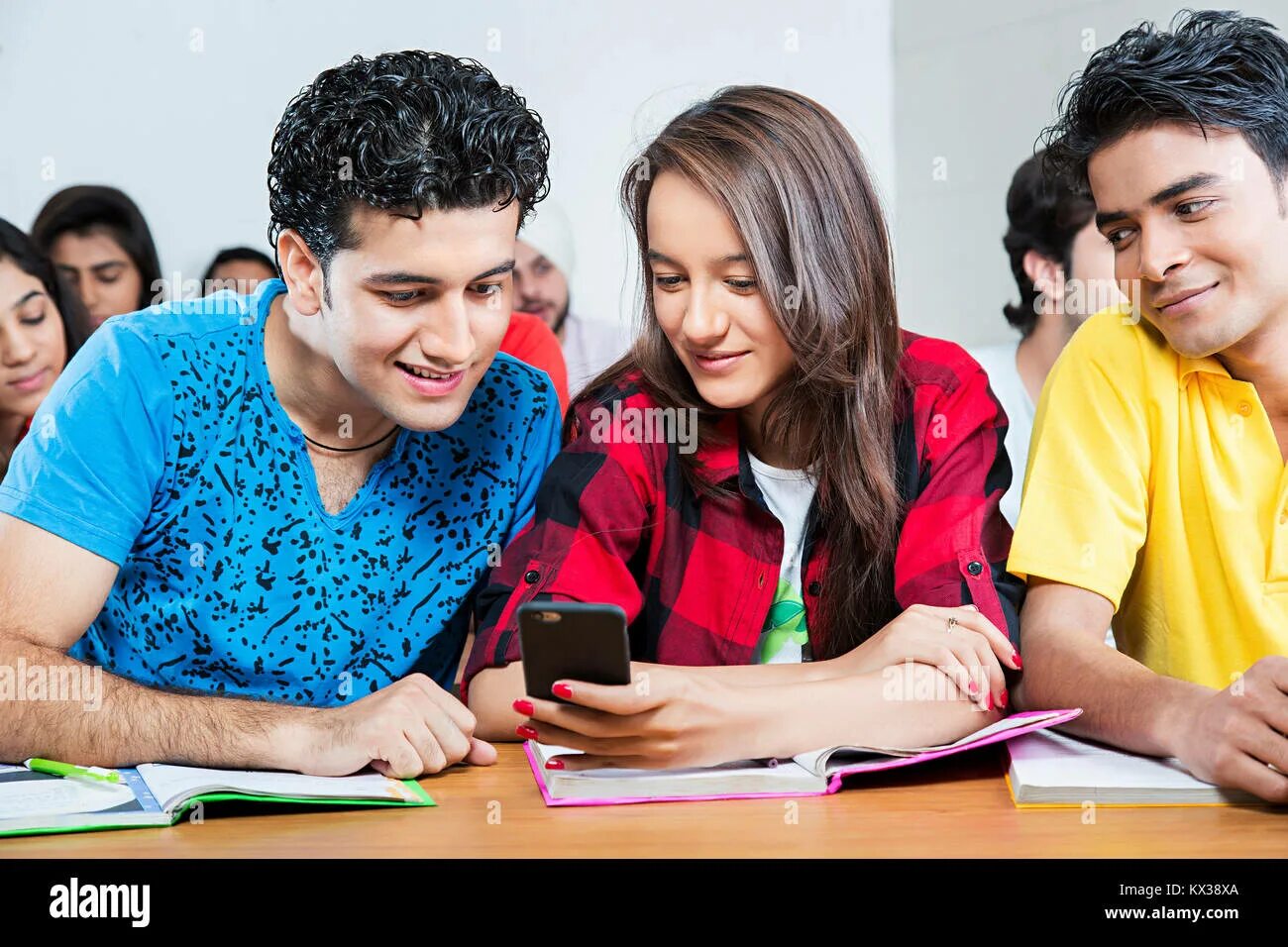 Chatted over. Pupil with Phone. Student is using Phone in class. Student with a Phone in class. IRC classmate.