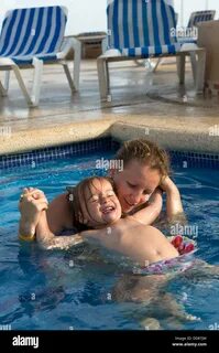 Download this stock image: Mother and Daughter playful in the pool, daughte...
