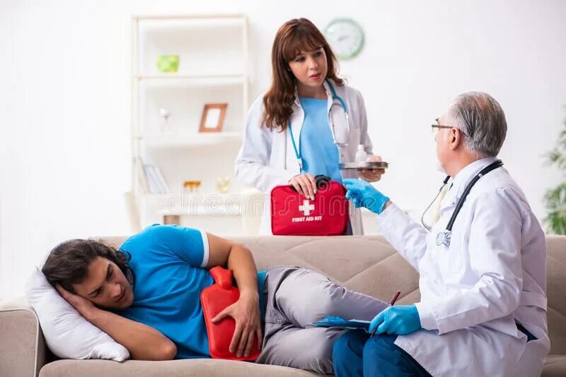 Two doctors. Two doctors visiting sick young man at home.