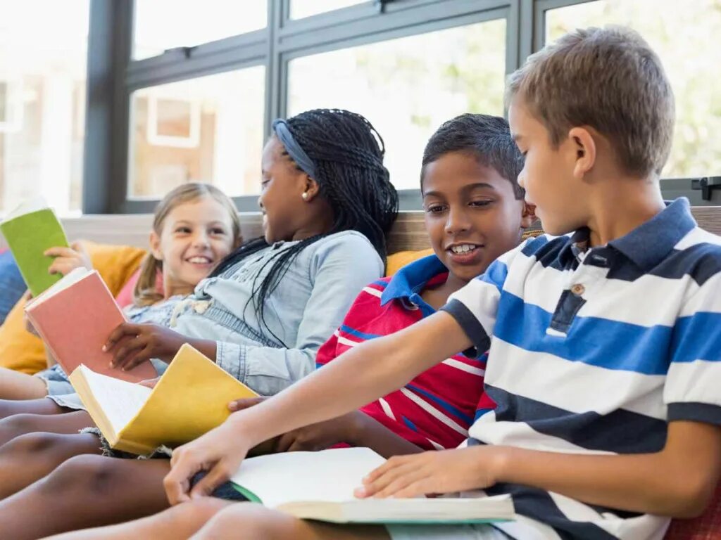 The pupils are in the classroom. Pupils reading books at school. a pupil reading book. talking about school. talk visit my school apart.