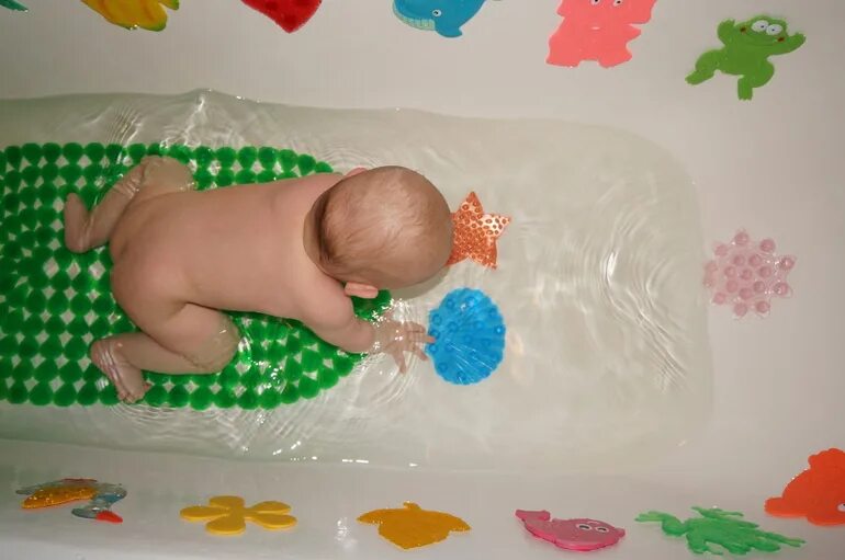 Купание новорожденного ребенка. Плавание грудничков в ванне. Шапка для плавания новорожденных. Купание ребенка в ванной 6 месяцев. Купание грудничка.