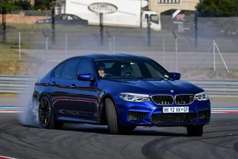 BMW M5, model year 2005-, black, driving, diagonal from the front, frontal  view, test track, Drift, drifting Stock Photo - Alamy