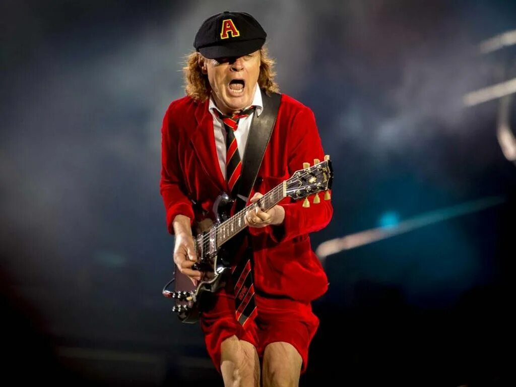 Гитарист АС ДС Ангус. Гитарист группы AC DC. Соло гитарист AC DC. AC DC Angus young молодой.